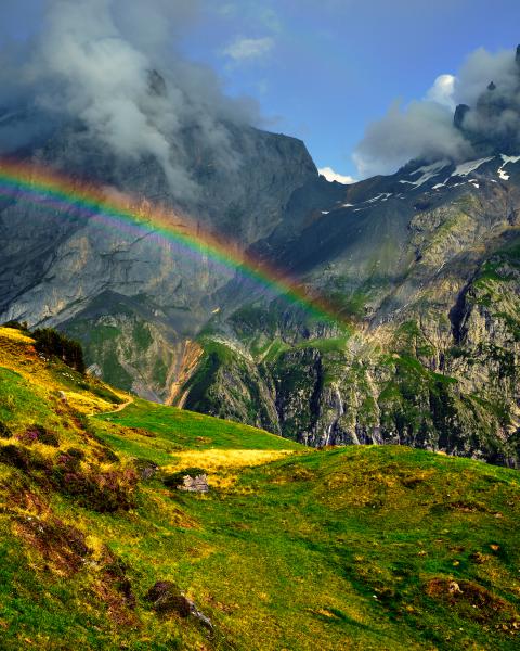 Rainbow with emerald mountains
